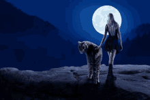 a woman standing next to a tiger looking at the moon