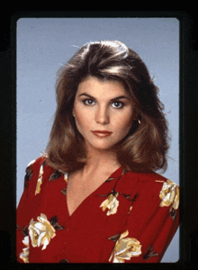 a woman is wearing a red floral dress