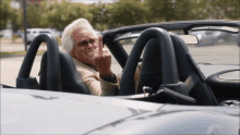 a man sitting in a car with his middle finger up