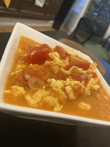 a close up of a plate of food with tomatoes and eggs