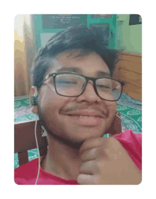 a young man wearing glasses and ear buds is smiling for the camera