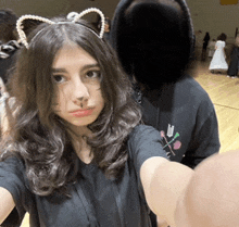 a girl with cat ears takes a selfie