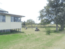 a man is riding a lawn mower in a yard