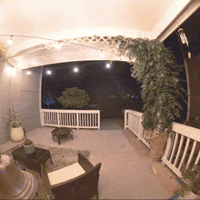 a balcony with a white railing and a potted plant on it