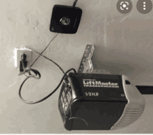 a liftmaster 1/2 hp garage door opener is mounted to a wall