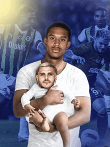 a man is holding a baby in front of a collage of soccer players