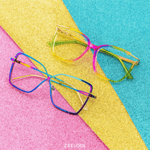 a pair of colorful glasses on a glittery surface with the word zeekool on the bottom right