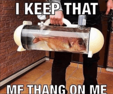 a person is holding a fish in a tank with the caption i keep that me thang on me