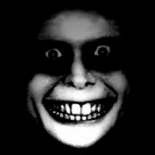 a black and white photo of a person 's face with a huge smile .