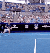 a man is playing tennis on a blue court in front of a crowd sponsored by united cup and pepperstone