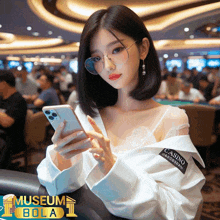 a woman wearing glasses and a white shirt that says casino on it is looking at her phone