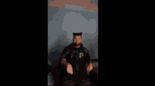 a man wearing cat ears and a t-shirt that says nyc is sitting on a bed