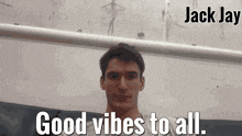 a man says " good vibes to all " in front of a wall