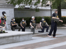 a group of fbi officers wearing masks and vests