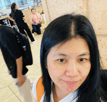 a woman taking a selfie in front of a sign that says ' sydney '