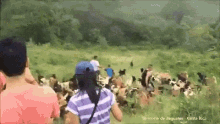 a group of people are walking through a grassy field with the words territorio de zaguates costa rica written on the bottom