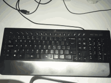 a black keyboard with the caps lock key in the middle of the keyboard