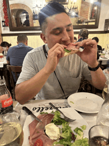 a man sits at a table with a coca cola bottle on it