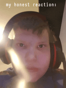 a boy wearing headphones with the words my honest reaction