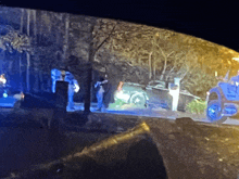 a blurred image of a police officer standing next to a car at night