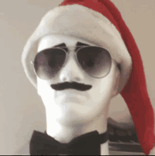 a mannequin wearing a santa hat sunglasses and a bow tie