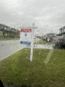 a real estate sign that says a vendre is in the rain