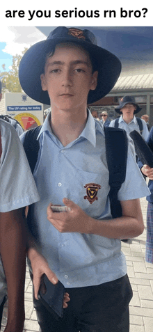 a boy wearing a hat holds a wallet in front of a sign that says uv rating for today