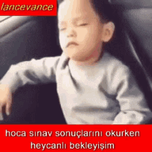 a little boy is sitting in a car with his eyes closed and a caption that says lancevance