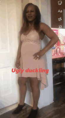 a woman in a pink dress is standing in front of a door with ugly duckling written on the bottom