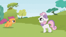 a couple of ponies are standing in a grassy area