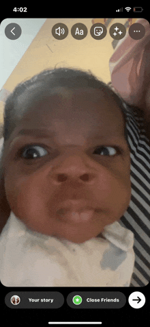 a baby 's face is shown on a cell phone screen