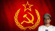 a man stands in front of a red flag with a hammer and sickle symbol