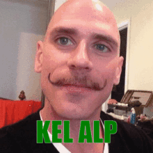 a man with a mustache and the name kel alp