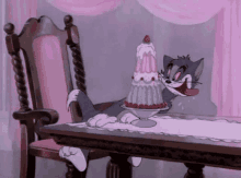 a cartoon cat is sitting at a table with a cake in his mouth