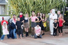 a group of people dressed up in halloween costumes pose for a picture