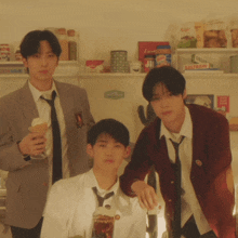 three young men are posing for a picture in front of a refrigerator that has the word saltwater on the bottom shelf