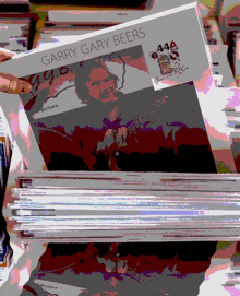 a stack of garry gary beers magazines are displayed on a table