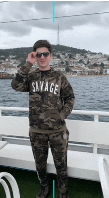 a young man wearing sunglasses and a savage hoodie