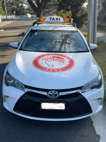 a white car with the word taxi on top