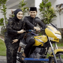 a man is riding a yellow motorcycle with a sony box on the side