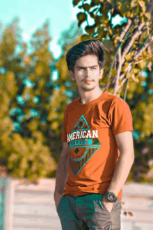 a young man wearing an orange shirt that says american