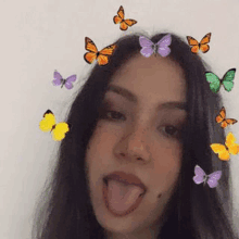 a girl with butterflies in her hair is sticking her tongue out and making a funny face .