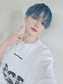 a person with blue hair is wearing a white t-shirt that says ' sg '