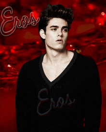 a man wearing a black sweater with eros written on the front