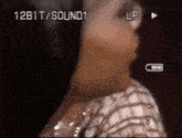 a close up of a person 's face with the words 12bit / sound1 visible