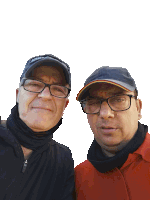 two men wearing glasses and hats are posing for a picture together