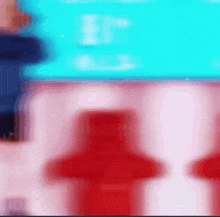 a blurred image of a person standing in front of a blue screen