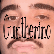 a close up of a man 's face with the name guntherino on it