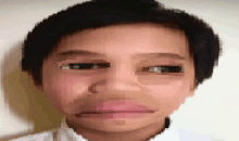 a pixelated image of a boy 's face with a white shirt on