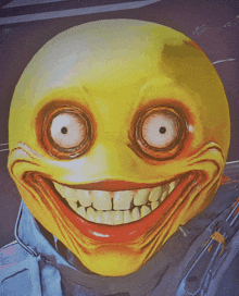 a yellow smiley face with big eyes and a red mouth